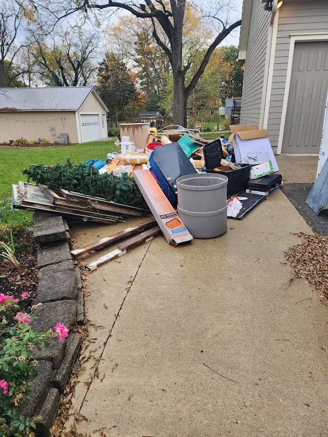 Dumpster being loaded with debris for Demolition Dumpster Rental in Morganton